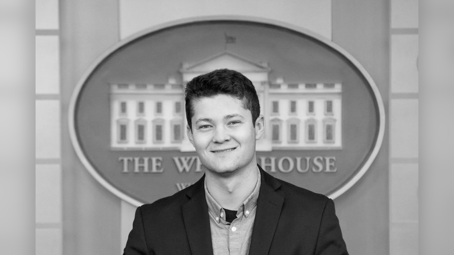 Tom Brenner with a White House logo behind him.